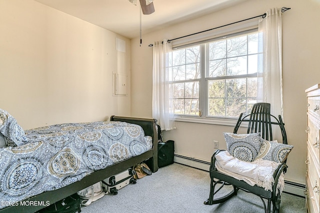 carpeted bedroom with baseboard heating and a ceiling fan