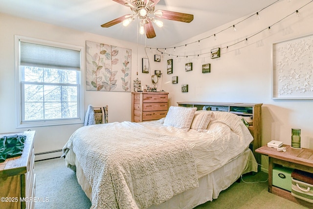 carpeted bedroom with ceiling fan and a baseboard radiator