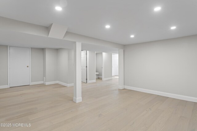 finished basement with recessed lighting, baseboards, and light wood-style flooring