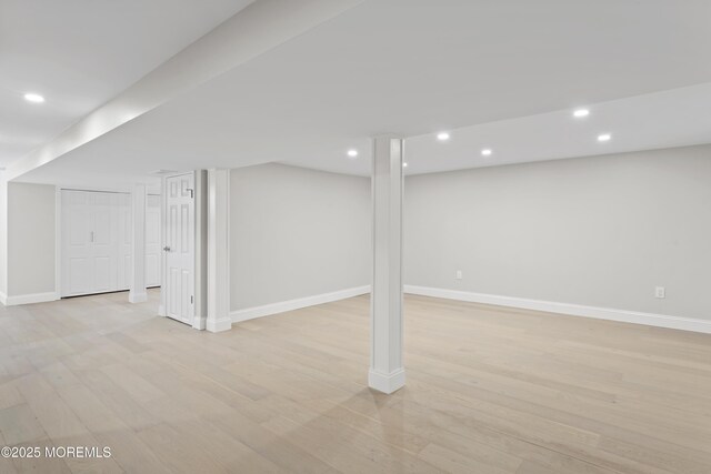 finished below grade area featuring recessed lighting, light wood-style floors, and baseboards