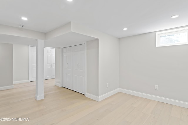 below grade area featuring light wood-style flooring, recessed lighting, and baseboards