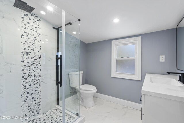 bathroom with baseboards, toilet, marble finish floor, and a stall shower