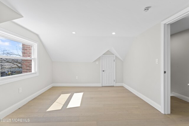 bonus room with recessed lighting, baseboards, lofted ceiling, and light wood-style flooring