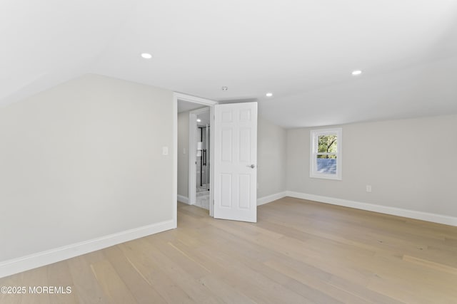 interior space with recessed lighting, light wood-type flooring, baseboards, and lofted ceiling