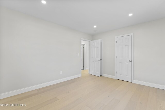 unfurnished bedroom with recessed lighting, baseboards, and light wood-type flooring