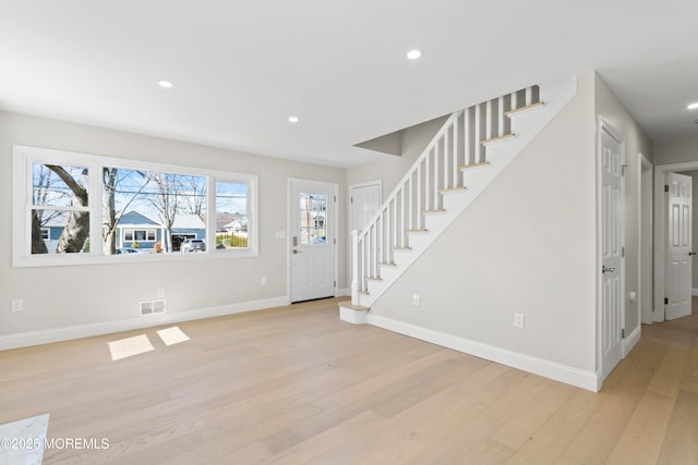 entrance foyer featuring stairway, visible vents, baseboards, recessed lighting, and light wood-type flooring