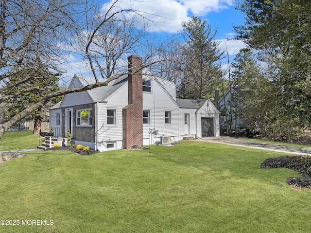 view of side of home featuring an attached garage, a yard, driveway, and a chimney