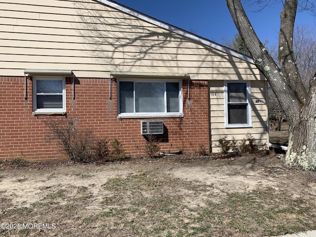 view of side of property with brick siding