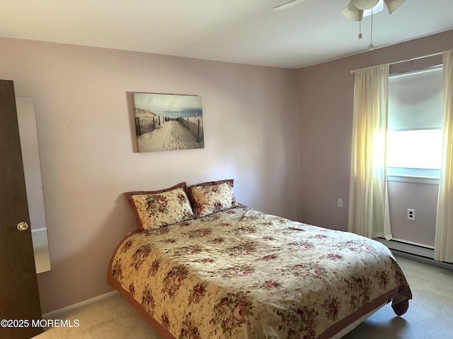 bedroom with ceiling fan, a baseboard heating unit, baseboards, and carpet floors