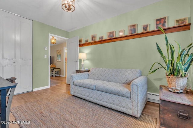 living area with wood finished floors, baseboards, and a baseboard radiator