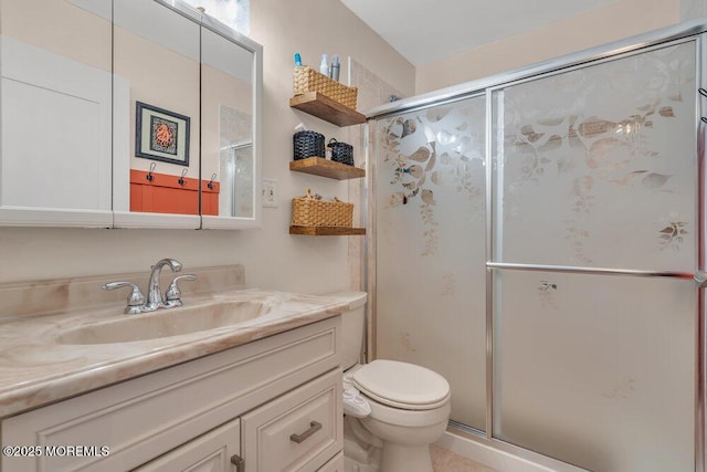 full bath featuring vanity, toilet, and a stall shower