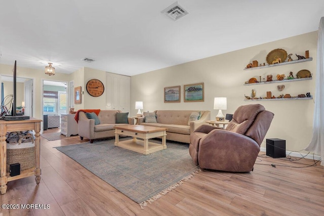 living room featuring wood finished floors and visible vents