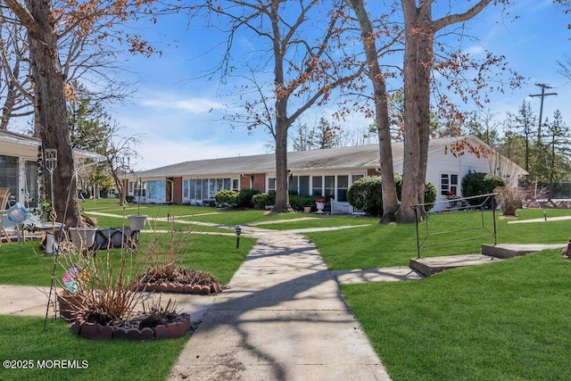 single story home with a front lawn and brick siding