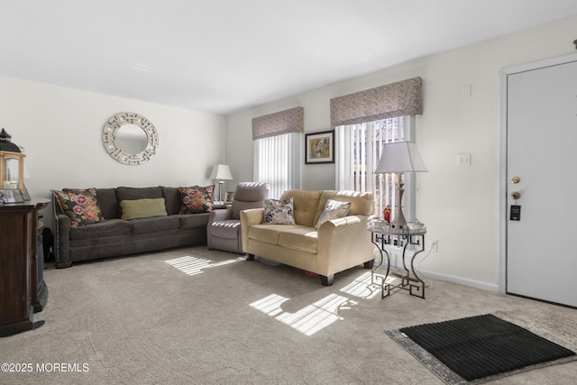 carpeted living area featuring baseboards