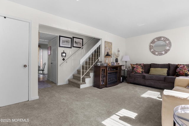 living area with stairway, baseboards, and carpet flooring