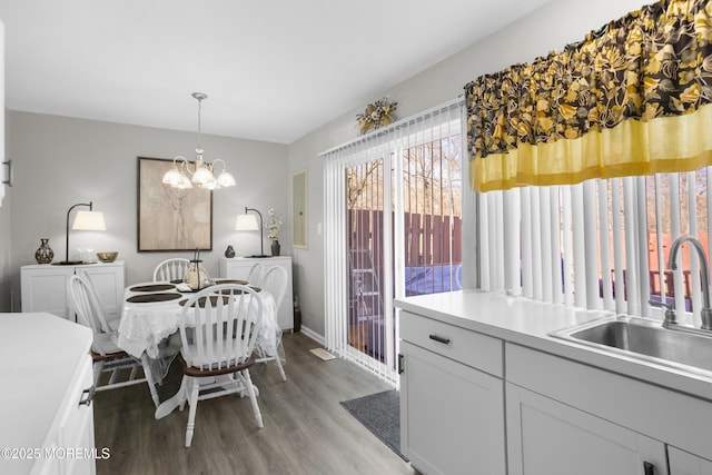 dining area featuring baseboards, a notable chandelier, and light wood finished floors