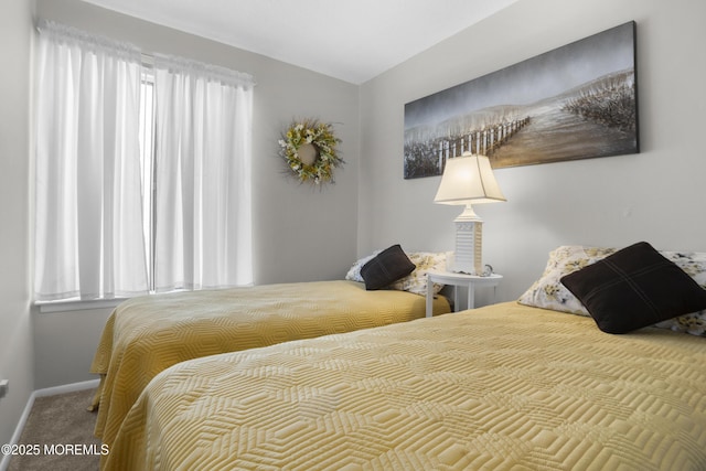 carpeted bedroom featuring baseboards