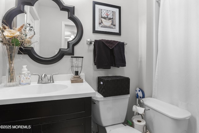 bathroom featuring vanity and toilet