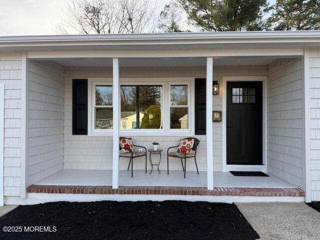 view of exterior entry with covered porch