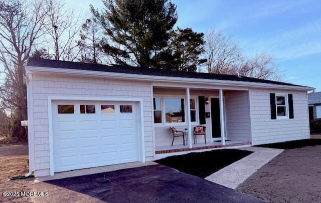 ranch-style house with a garage and driveway