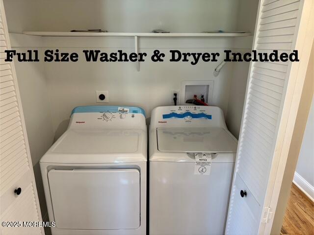 clothes washing area with separate washer and dryer and laundry area