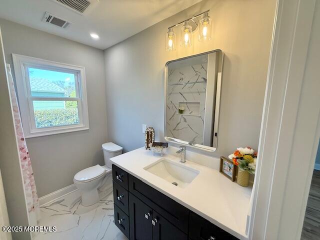 bathroom with visible vents, marble finish floor, toilet, and vanity