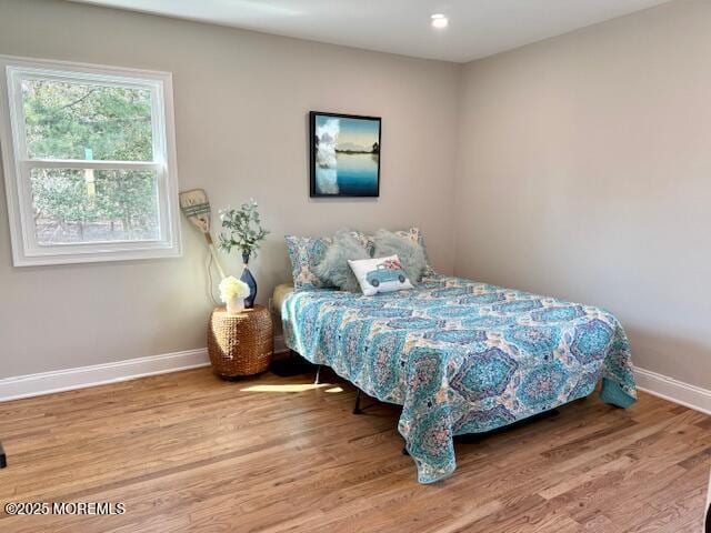 bedroom featuring baseboards and wood finished floors