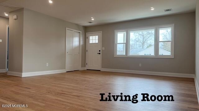 foyer with visible vents, recessed lighting, wood finished floors, and baseboards