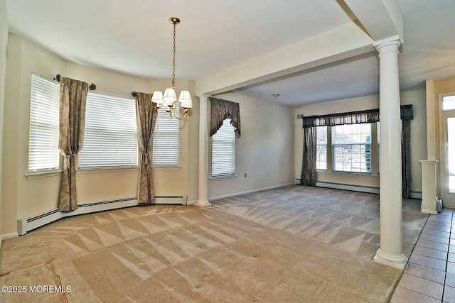 spare room with a baseboard radiator, carpet floors, and ornate columns