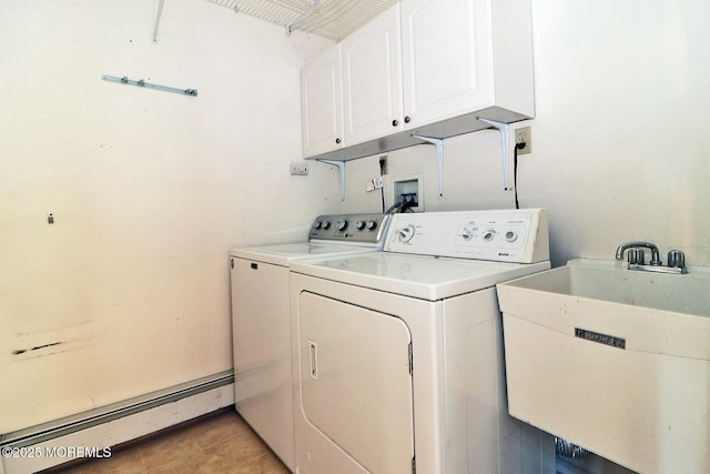 laundry area with washer and clothes dryer, a sink, a baseboard heating unit, cabinet space, and light tile patterned floors