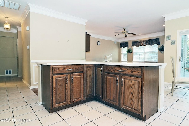 kitchen featuring crown molding, light tile patterned floors, and visible vents