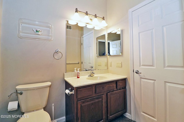 bathroom with visible vents, toilet, and vanity