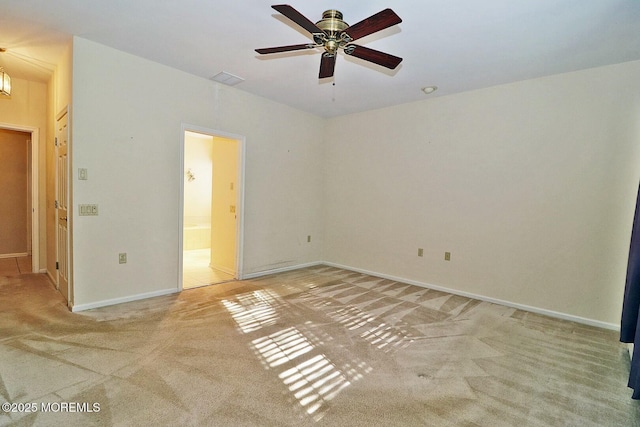 unfurnished bedroom featuring connected bathroom, visible vents, baseboards, and light carpet