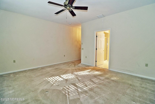 unfurnished room with visible vents, ceiling fan, carpet, and baseboards