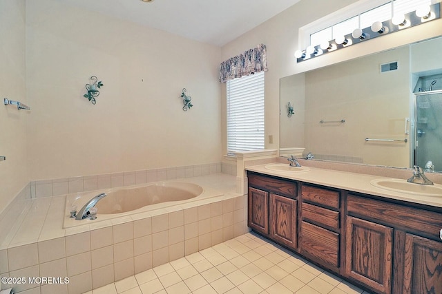 full bathroom featuring a sink, visible vents, a garden tub, and double vanity