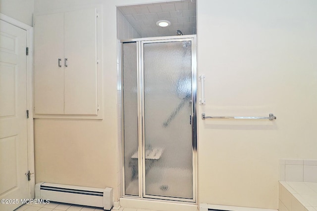 full bathroom with a stall shower and a baseboard radiator