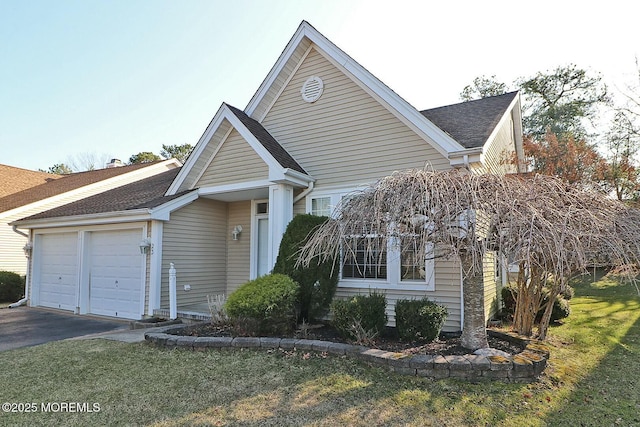 view of front of home with an attached garage and roof with shingles