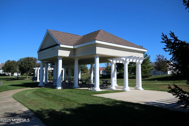 view of property's community with a patio area, a lawn, and a pergola