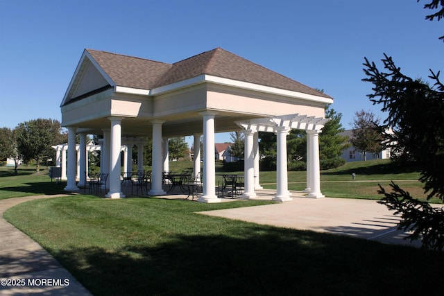 view of property's community featuring a pergola and a yard