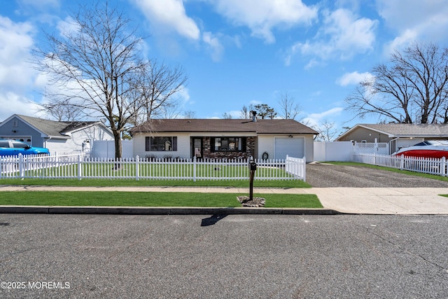 view of front of house with a fenced front yard, a front yard, an attached garage, and driveway