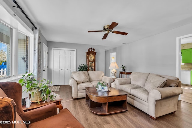 living room with ceiling fan and wood finished floors