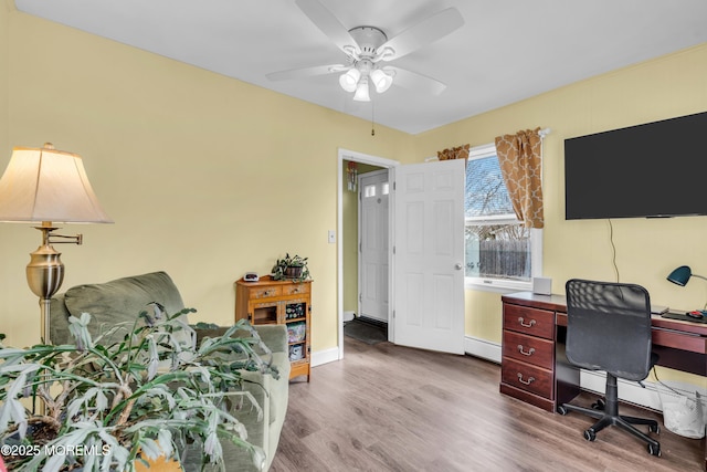 office with baseboards, wood finished floors, and a ceiling fan