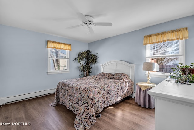 bedroom featuring a baseboard heating unit, ceiling fan, and wood finished floors