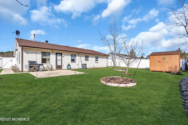 rear view of house featuring a storage unit, an outbuilding, a gate, a patio, and a fenced backyard