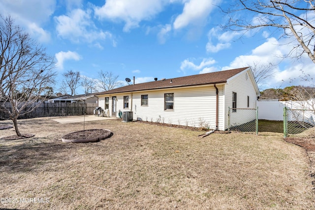 back of house with a patio area, central AC unit, a lawn, and a fenced backyard