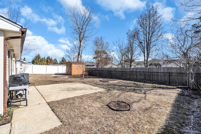 view of yard featuring a fenced backyard, a patio, an outdoor structure, and a shed