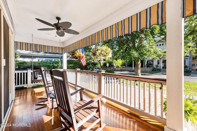 wooden deck with a ceiling fan and covered porch