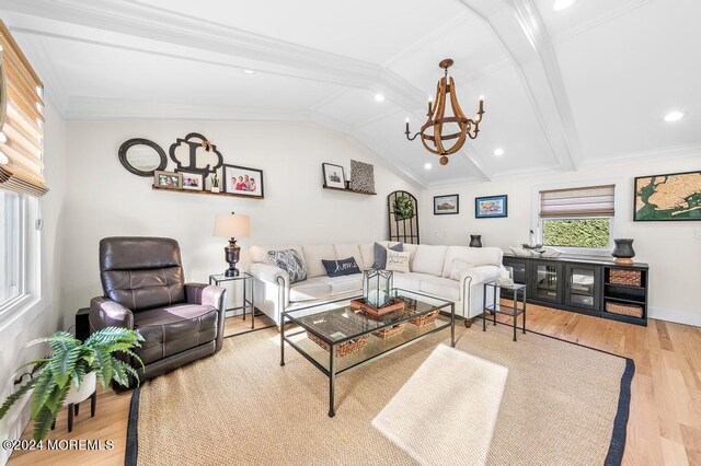 living room with lofted ceiling with beams, wood finished floors, an inviting chandelier, crown molding, and baseboards