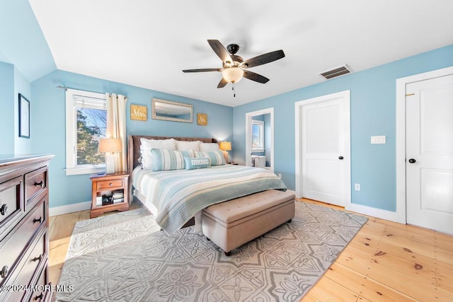 bedroom with visible vents, ceiling fan, light wood-type flooring, and baseboards