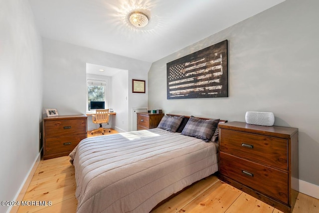 bedroom with light wood-style flooring and baseboards